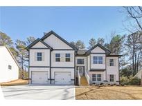 Two-story house with white siding, gray accents, and a two-car garage at 3278 Greenhill Dr, Villa Rica, GA 30180