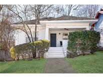 Charming white brick home with a covered porch and well-manicured lawn at 1797 Hosea L Williams Se Dr, Atlanta, GA 30317