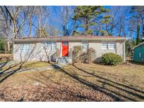 Ranch style home with red front door, gray exterior, and small yard at 454 Oak Se Dr, Atlanta, GA 30354