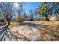 Ranch home with a long driveway and mature trees at 2725 Rainbow Forest Dr, Decatur, GA 30034