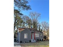 Gray house with red door, surrounded by trees at 678 Charlotte Nw Pl, Atlanta, GA 30318