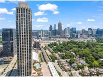 Aerial view of a city skyline with high-rise buildings and lush green trees at 270 17Th Nw St # 809, Atlanta, GA 30363