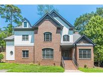 Brick and white two-story house with gray accents and landscaping at 630 Darlington Commons Ne Ct, Atlanta, GA 30305