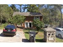 Brick house with a yard and driveway, offering curb appeal at 345 Lexington Dr, Lawrenceville, GA 30046