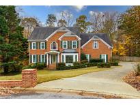 Brick home with a two-car driveway and landscaping at 3799 Halisport Nw Ln, Kennesaw, GA 30152