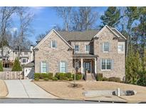 Two-story brick home with gray shutters, landscaped lawn, and driveway at 4016 Matty Ne Dr, Marietta, GA 30066