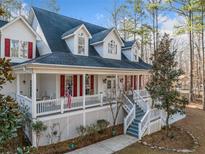 Charming two-story traditional-style home with a welcoming porch and red shutters, nestled among mature trees at 10 Moss Landing Se Rd, Acworth, GA 30102