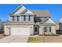 Two-story house with gray siding, brick accents, and a white door at 412 Vermeer Ct, Locust Grove, GA 30248