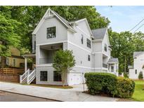 Two-story craftsman style home with gray siding, white trim, and a detached two-car garage at 628 Robinson Se Ave # A, Atlanta, GA 30312
