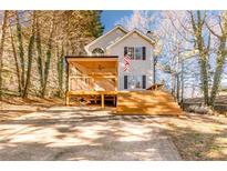 Two-story house with a large deck and screened porch at 2605 Poplar Ln, Cumming, GA 30041