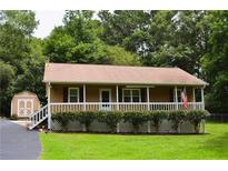 Ranch home with covered porch, storage shed, and landscaped yard at 6 Turner Ln, Dallas, GA 30157