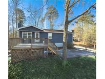 Ranch home with deck, fenced yard, and wooded area at 8791 Daerwater Dr, Winston, GA 30187