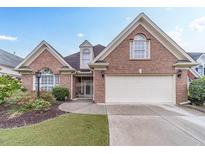 Brick house with a two-car garage and landscaped front yard at 2040 Hickory Station Cir, Snellville, GA 30078