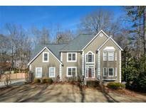 Two-story house with gray siding, dark roof, and landscaping at 103 Ashwood N Ct, Stockbridge, GA 30281
