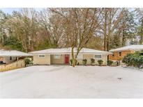 Ranch style home with red front door, snow covered yard at 2792 Plantation Dr, Atlanta, GA 30344