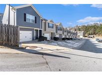 Row of townhouses with attached garages, driveways, and landscaping at 915 Highwood Ln, Atlanta, GA 30344