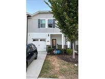 Charming townhome with gray siding, white trim, and a two-car garage at 5602 Plain Field Ln, Lilburn, GA 30047