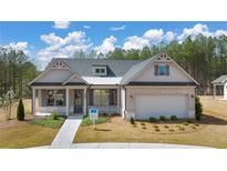 Craftsman style home with gray siding, brick accents, and a two-car garage at 3772 Tielman St, Snellville, GA 30078