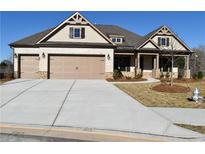 Charming single-Gathering home with a two-car garage, brick and siding exterior, and well-manicured landscaping at 1609 Tielman Way, Snellville, GA 30078