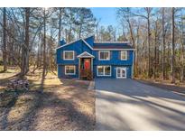 Newly renovated blue house with a red door and wooden stairs at 2139 Logan Dr, Jonesboro, GA 30236