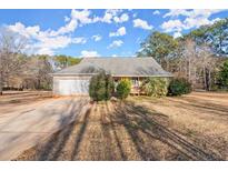 Ranch home with attached garage and large yard at 1489 New Hope Rd, Locust Grove, GA 30248