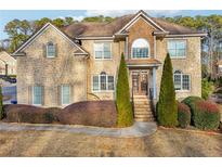 Beautiful two-story house with stone exterior and landscaping at 408 Edmond Ct, Suwanee, GA 30024