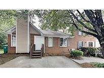 Brick townhouse exterior with steps leading to the entrance and a small parking area at 2115 Charter Ln, Lithonia, GA 30058