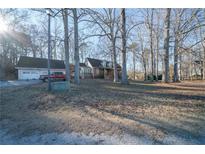 Ranch home with attached garage and spacious yard on wooded lot at 633 Duncan Rd, Oxford, GA 30054