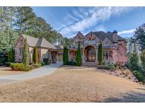 Stunning stone house with 3-car garage & landscaped yard at 922 Little Darby Ln, Suwanee, GA 30024