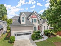 Two-story house with beige exterior, white garage door, and landscaping at 485 Shelli Ln, Roswell, GA 30075