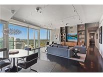 Modern living room with city views, hardwood floors, and stylish furniture at 3325 Piedmont Ne Rd # 3005, Atlanta, GA 30305