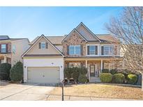 Two-story house with stone accents and a large front yard at 558 Olympic Way, Acworth, GA 30102