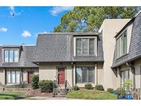 Attractive exterior of townhome with a red door and nicely landscaped lawn at 17 Ivy Gates Ne, Atlanta, GA 30342