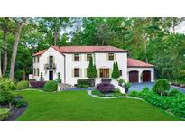 Stunning two-story home featuring a red tile roof, lush landscaping, and a well-manicured front lawn at 1598 W Sussex Rd, Atlanta, GA 30306