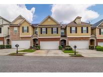 Charming townhomes with a mix of brick and siding exteriors and attached one-car garages at 53 Providence Oak Ct, Lawrenceville, GA 30046