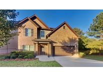 Brick two-story house with attached garage and landscaping at 281 Janney Cir, Mcdonough, GA 30253