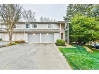 Attractive two-story townhome with a two-car garage and well-manicured lawn at 4083 Audubon Dr, Marietta, GA 30068