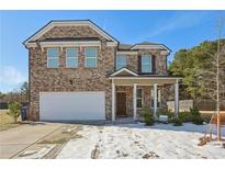 Two-story brick home with a large front yard and attached garage at 1920 Pearson St, Loganville, GA 30052