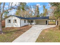 Charming ranch home with covered carport and well-manicured lawn at 4104 Snapfinger Way, Decatur, GA 30035