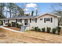 Charming single-story home with a painted brick exterior, neat landscaping, and a welcoming front entrance at 2771 Ridge Park Dr, Tucker, GA 30084