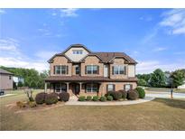 Two story brick home with landscaped yard and large driveway at 4302 Maclaren Ct, Powder Springs, GA 30127