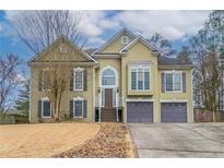 Two-story house with a large front yard, two-car garage, and neutral color scheme at 4902 Ascot Nw Blf, Acworth, GA 30102