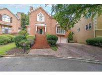 Brick home with a large front yard and driveway at 1005 Lenox Valley Ne Dr, Atlanta, GA 30324