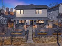Two-story house with a front porch and a fenced yard at 230 Woodward Se Ave, Atlanta, GA 30312