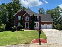 Charming two-story brick home with well-maintained landscaping, two car garage and a spacious driveway at 1886 Clay Sw Dr, Marietta, GA 30064