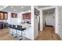 Modern kitchen with stainless steel appliances and breakfast bar at 565 Peachtree Ne St # 1303, Atlanta, GA 30308