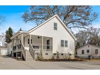 White house with a large porch and driveway at 1097 Dell Se Ave, Smyrna, GA 30080