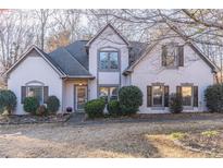 Two-story house with gray siding, brown shutters, and landscaping at 1630 Victoria Chase, Cumming, GA 30041