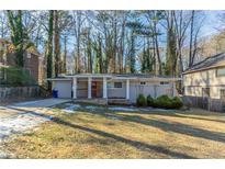 Ranch style home with a red door and covered porch at 1883 La Mesa Ln, Decatur, GA 30032