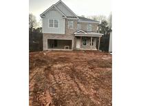 Two-story house with attached garage and unfinished yard at 566 Abbott Se Ct, Atlanta, GA 30354